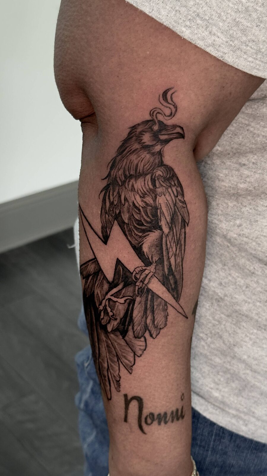 Custom raven and lightning tattoo with script name