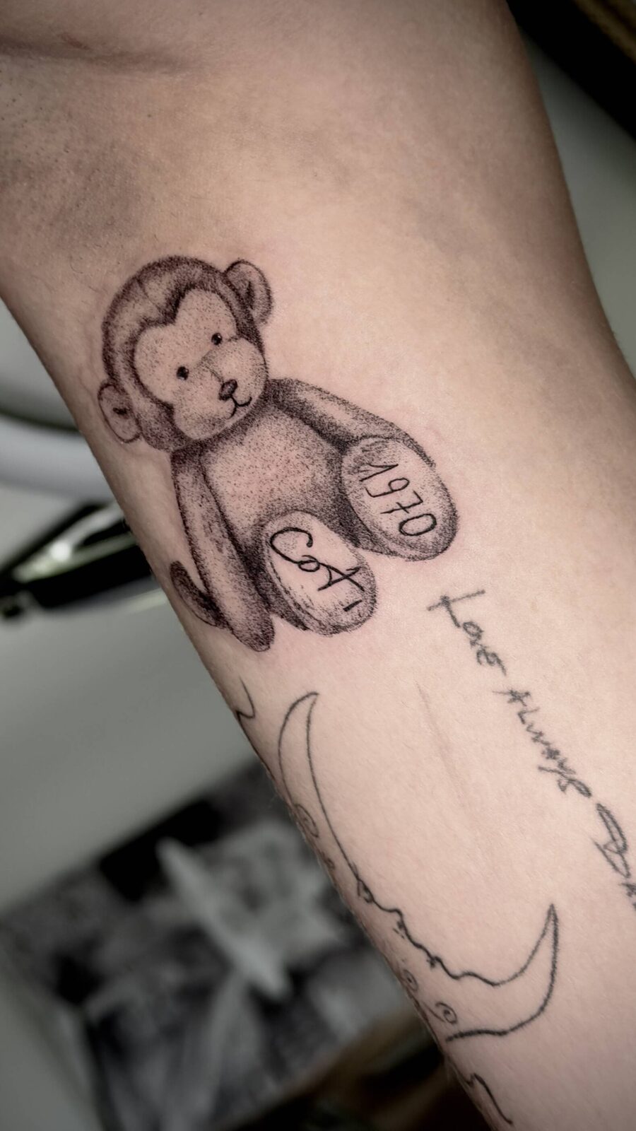Teddy bear tattoo with fine script lettering