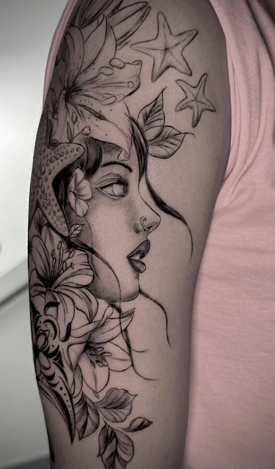 Fine line floral portrait tattoo by Ninonika