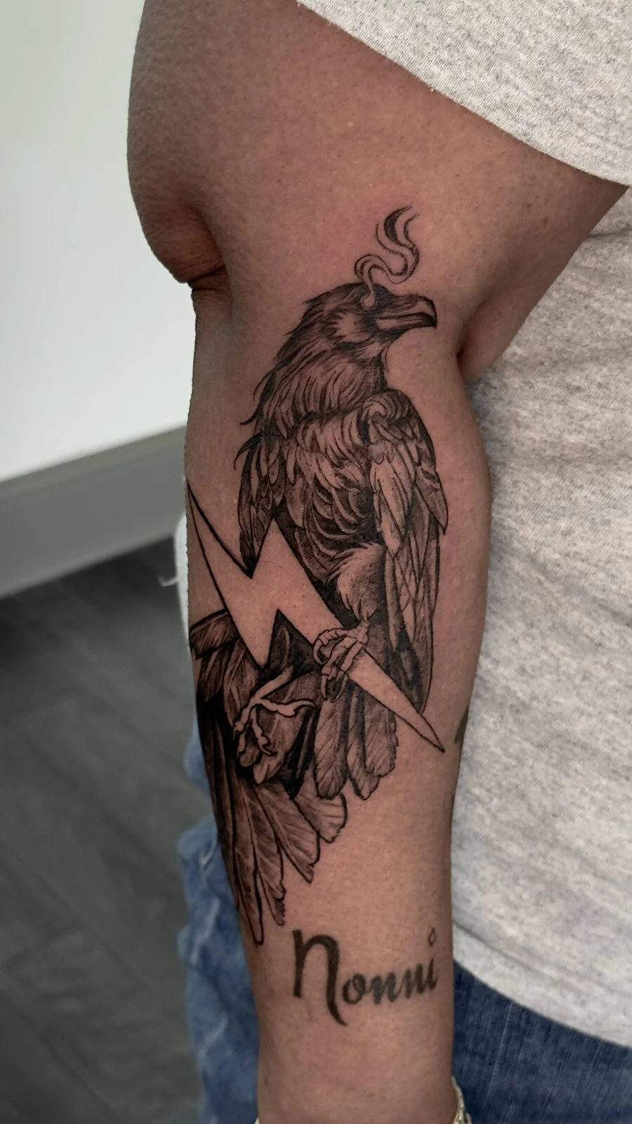 Custom raven and lightning tattoo with script name