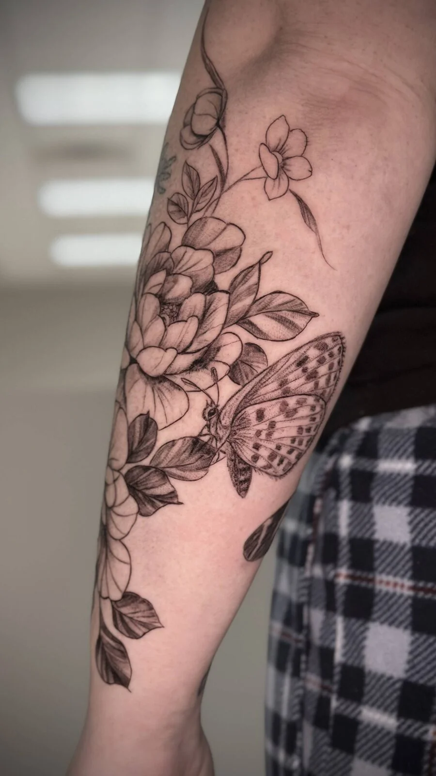 Floral and butterfly forearm tattoo